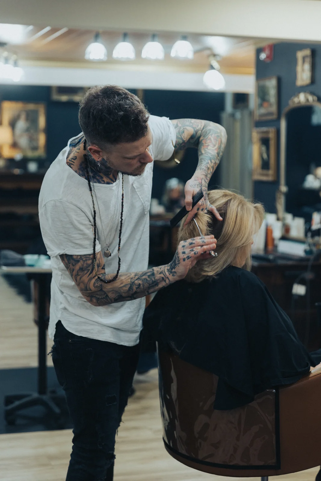 Derek Piekarski cutting a guest’s hair at Craft Collective