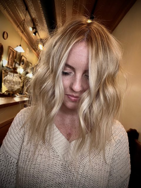 Blonde cut with curtain bangs by Craft Collective Salon Group