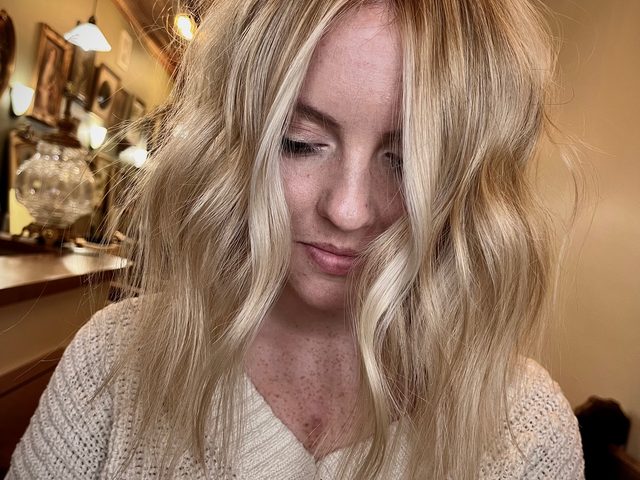 Blonde cut with curtain bangs by Craft Collective Salon Group