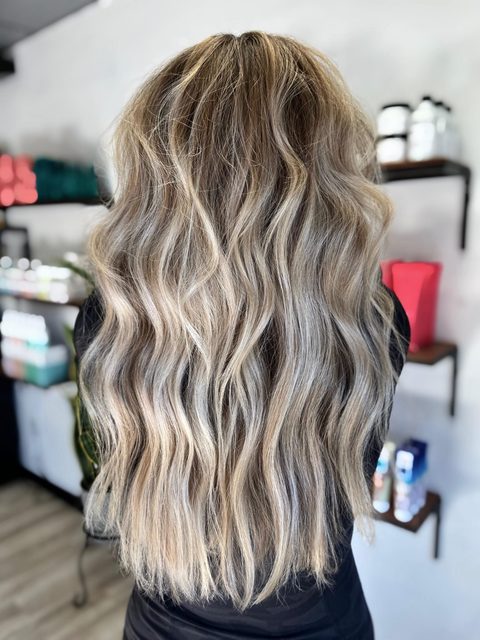 Long lived-in blonde by Craft Collective Salon Group