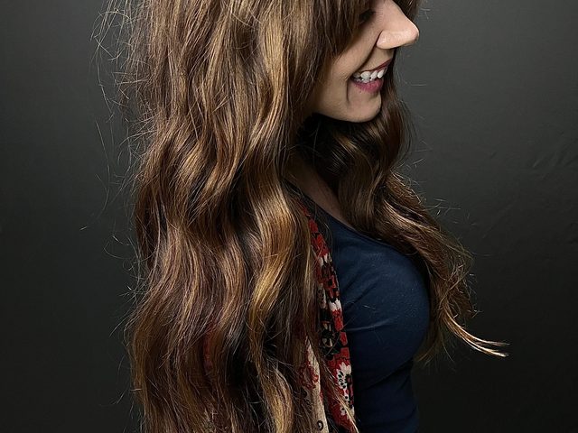 Long brunette shag with curtain bangs by Craft Collective Salon Group