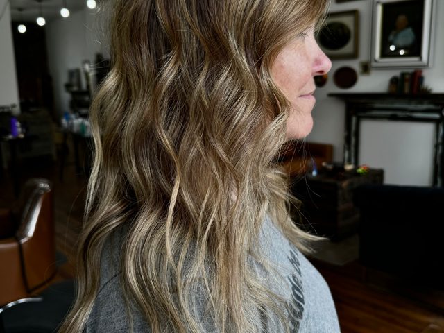 Face-framing blonde highlights by Craft Collective Salon Group