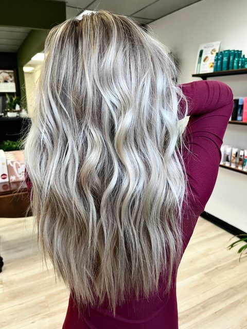 Long platinum blonde waves by Craft Collective Salon Group