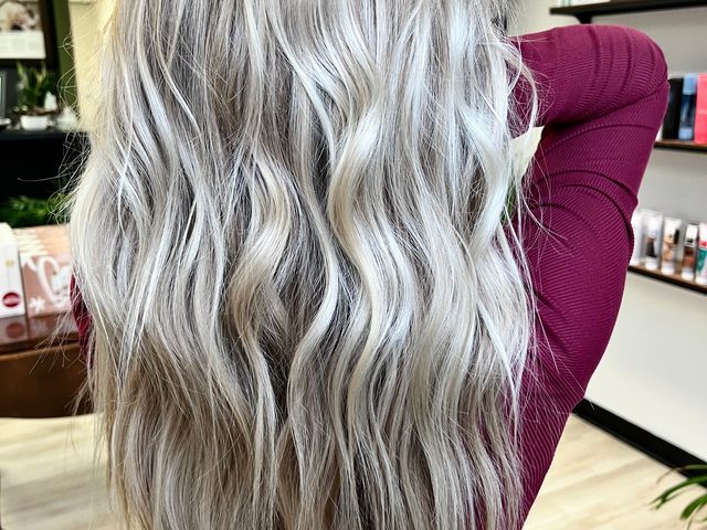 Long platinum blonde waves by Craft Collective Salon Group